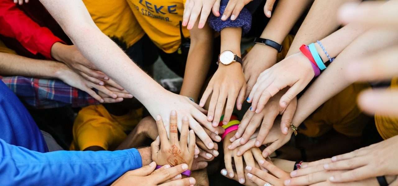 Group of camper's hands joined in the middle
