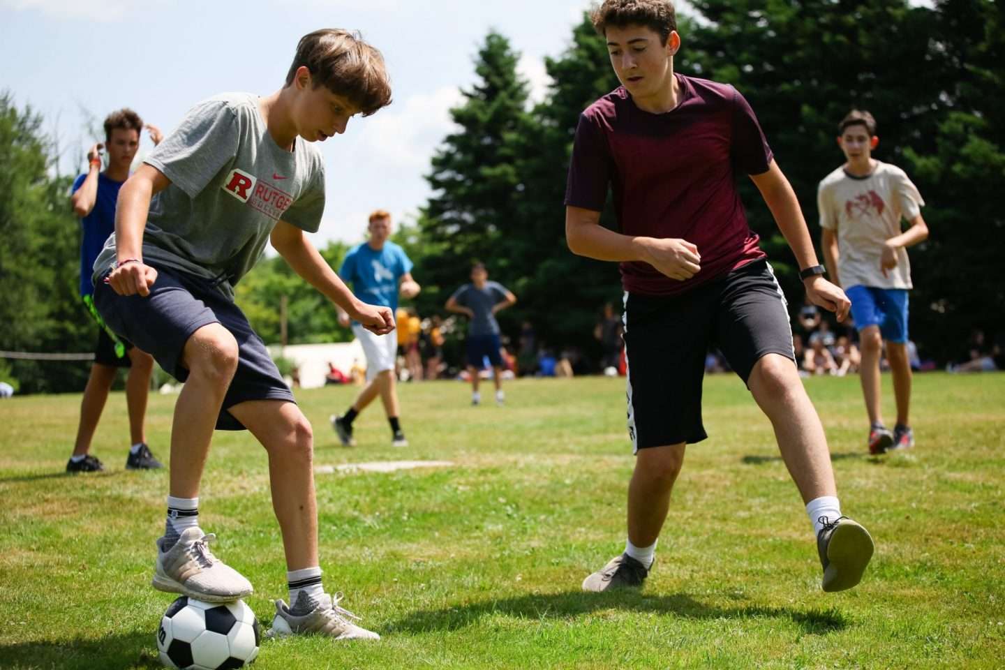 Group of campers playing soccer on the playing fields