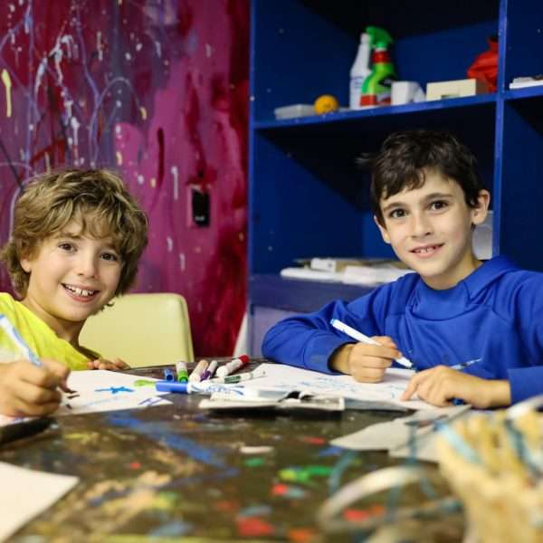 Two campers drawing in the art room