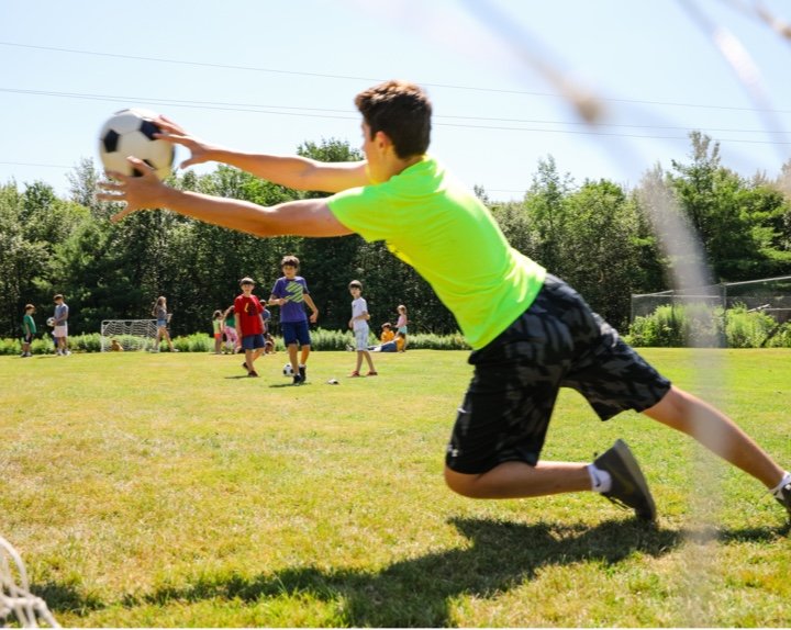Camper saving a goal during a game of soccer