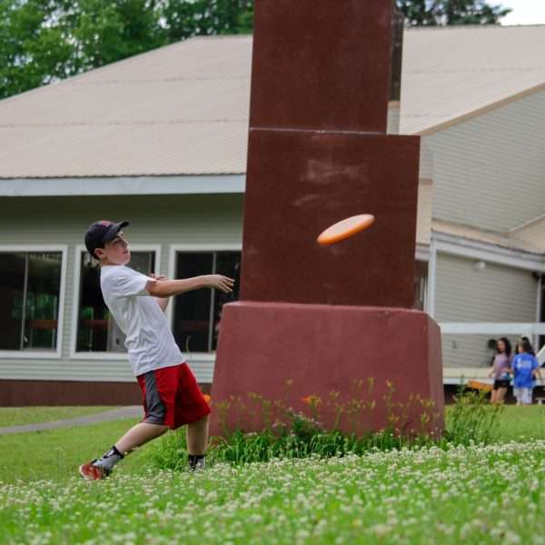 Male camper throwing a frisbee