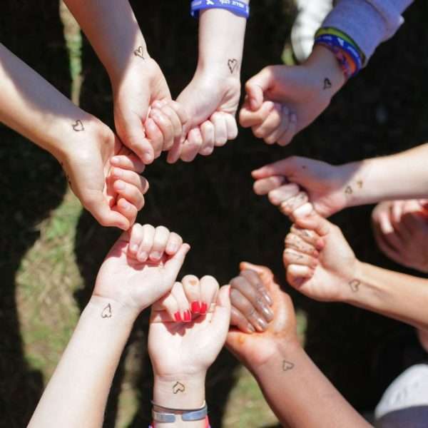 Group of campers hands showing group temporary tattoos