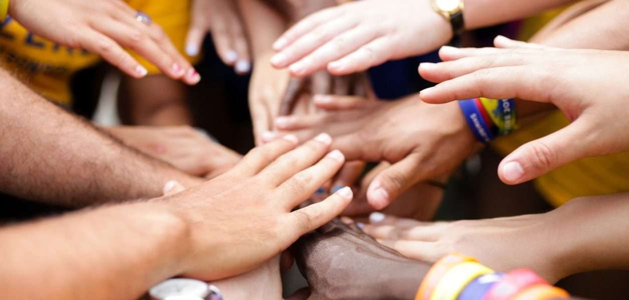 Group of camper's hands joining in the center