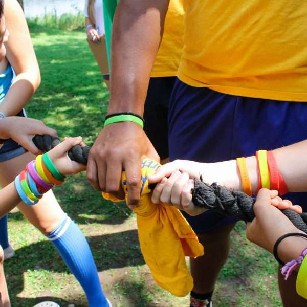 Camp staff working together during a tug-of-war