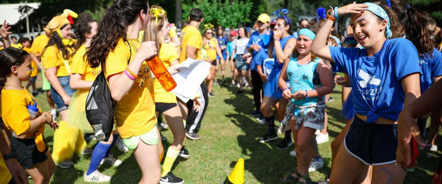 Group of campers wearing either blue or yellow taking part in a color war!
